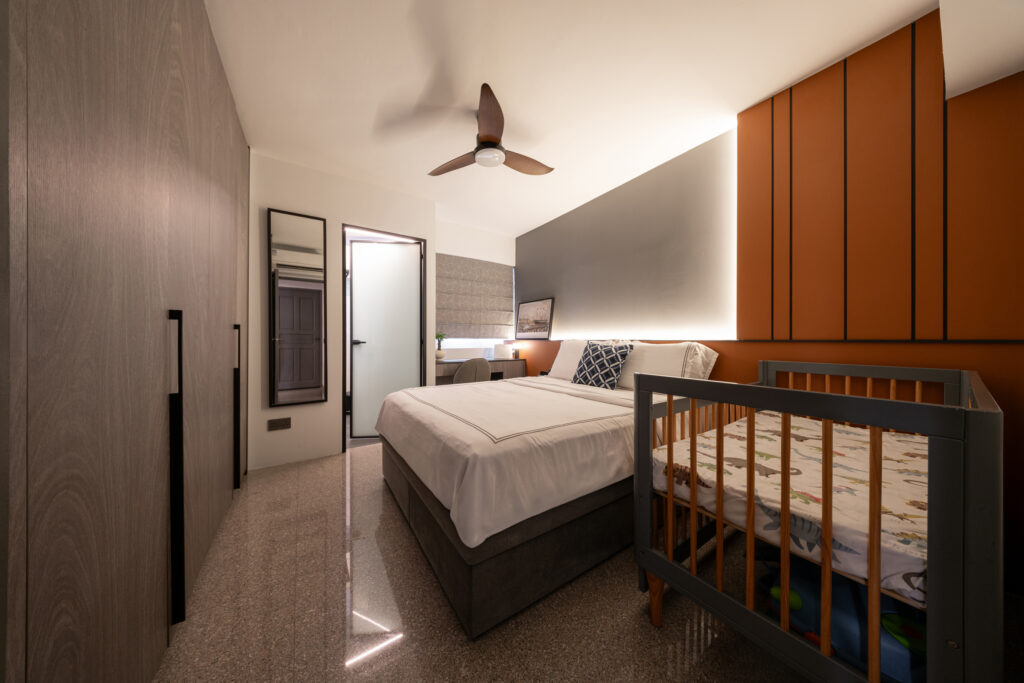 Expanded master bedroom featuring a baby cot and built-in wardrobes in a 4-room HDB renovation.
